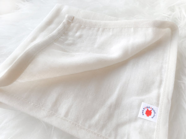 Folded dye free GOTS certified organic cotton hanky for use as a wash cloth, burp cloth, bib, scarf or security blanket