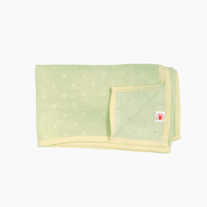 Pokka Kids lime polka dot GOTS certified organic cotton blanket for use as a stroller cover, or nursing cover