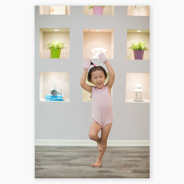 baby girl posing ballerina wearing pink GOTS certified organic cotton bodysuit and mittens designed for eczema