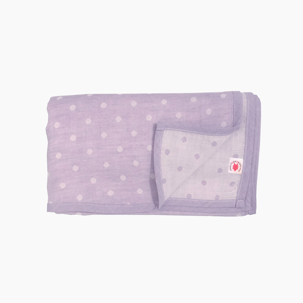 Folded purple polka dot GOTS certified organic cotton blanket for use as a stroller cover, or nursing cover