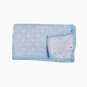 Folded blue polka dot GOTS certified organic cotton blanket for use as a stroller cover, or nursing cover