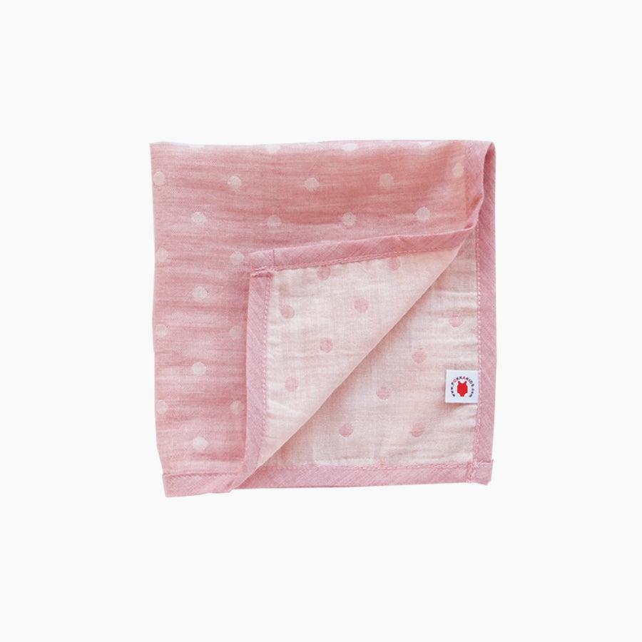 Folded pink GOTS certified organic cotton hanky for use as a wash cloth, burp cloth, bib, scarf or security blanket
