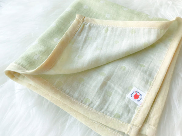 Folded lime GOTS certified organic cotton hanky for use as a wash cloth, burp cloth, bib, scarf or security blanket